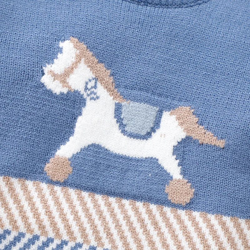 Detailed close-up of the classic white and beige woven horse motif and striped mid-section pattern on the baby boy sweater.