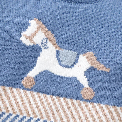 Detailed close-up of the classic white and beige woven horse motif and striped mid-section pattern on the baby boy sweater.