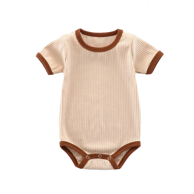 Kidsely Oatmeal Milk: Full front view of the creamy neutral ribbed baby romper with dark mocha contrast trim.