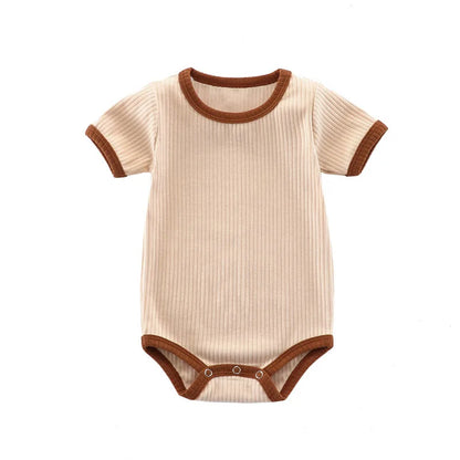 Kidsely Oatmeal Milk: Full front view of the creamy neutral ribbed baby romper with dark mocha contrast trim.