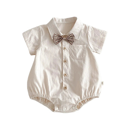 Flat lay of the off-white cotton baby gentleman romper against a plain background.