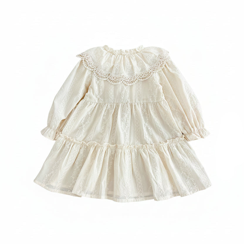 Back view of off-white cottagecore girls long sleeve tiered dress with wide lace-trimmed ruffled collar and flowy skirt.
