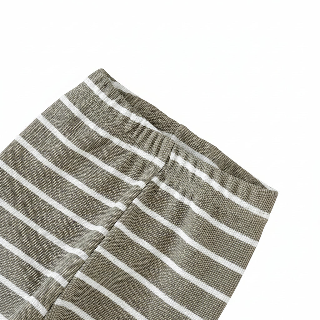 Close-up of baby pants featuring olive green and white horizontal stripes and a comfortable elastic waistband.