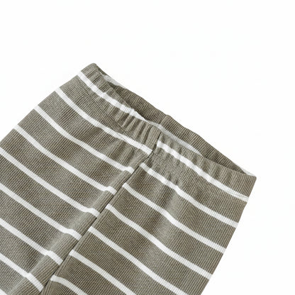 Close-up of baby pants featuring olive green and white horizontal stripes and a comfortable elastic waistband.