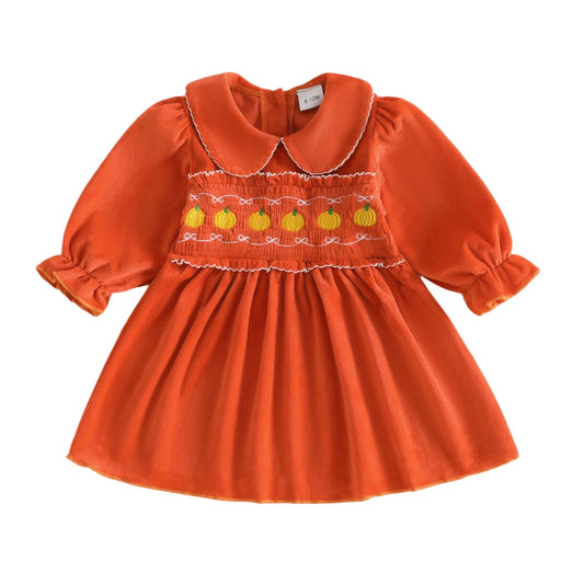 Orange long sleeve baby and toddler girls Halloween dress featuring smocked pumpkin embroidery and a white-trimmed Peter Pan collar.