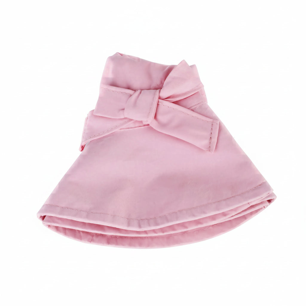 The pink wide brim cotton sun hat folded completely flat, demonstrating its packable, travel-friendly, and compact design for easy storage.