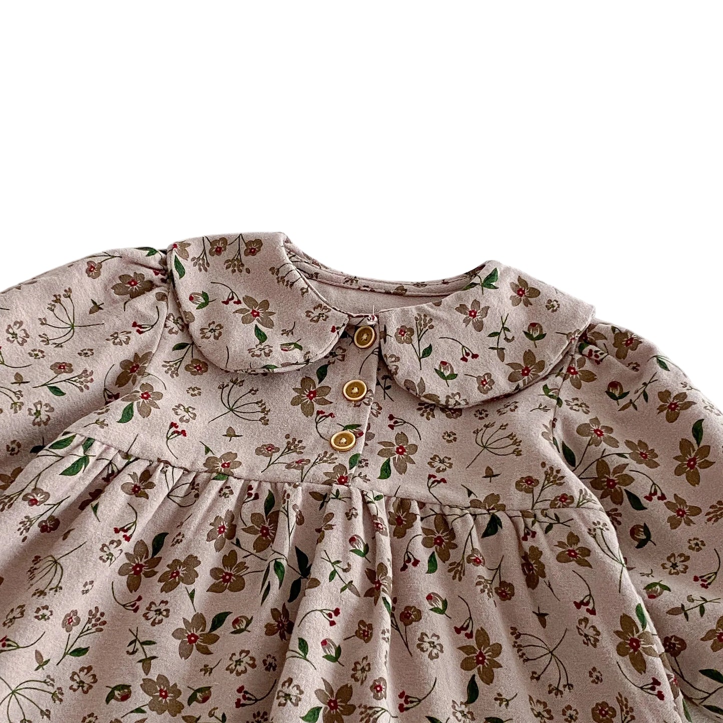 Close-up of the classic Peter Pan collar, gently gathered chest, and wooden-style front buttons on the floral toddler dress.
