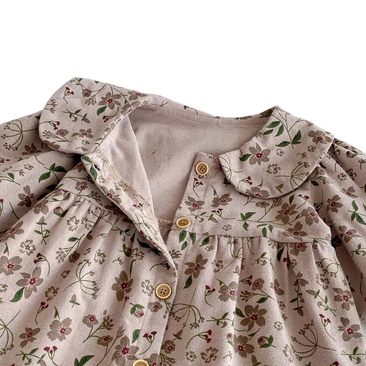 Close-up of the vintage Peter Pan collar and functional wooden-style front buttons on the Kidsely baby romper.