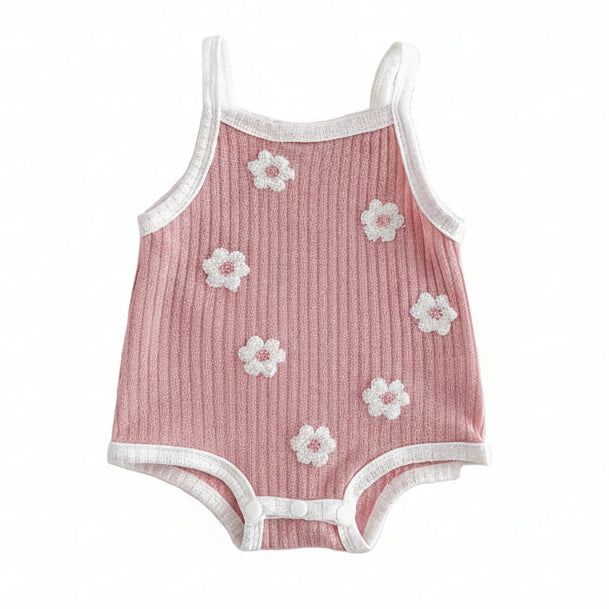 Pink ribbed sleeveless baby girl romper with white 3D flower towel embroidery on a clean white background.