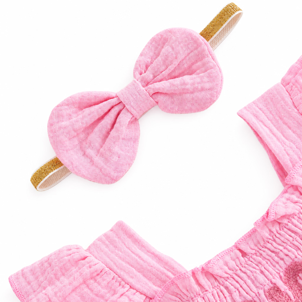 Close-up of the textured pink bow headband accessory included with the strawberry romper set