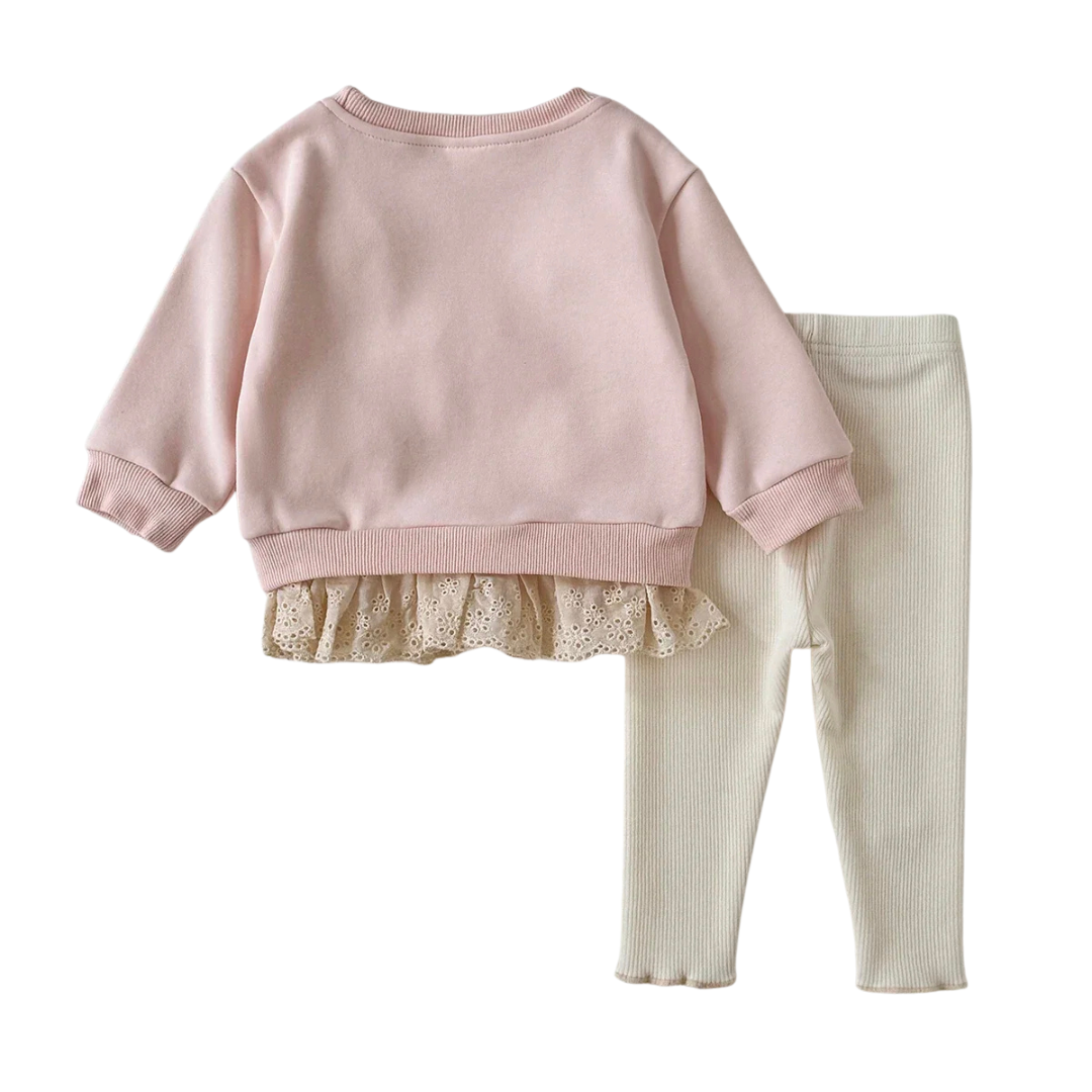 Back view of the baby girl pink pullover sweatshirt with lace trim and cream ribbed leggings set on a white background.
