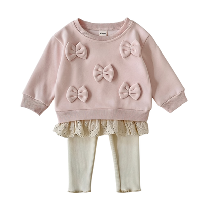 Front view of the baby and toddler girl pink 3D bow sweatshirt and cream ribbed leggings 2-piece outfit set on a white background.