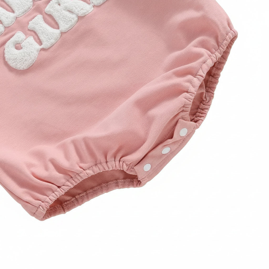Close-up of the bottom snap closures on the pink "Daddy's Girl" baby bubble romper for easy diaper changes.