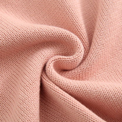 Macro close-up view of the soft pink cotton blend cable knit fabric texture.