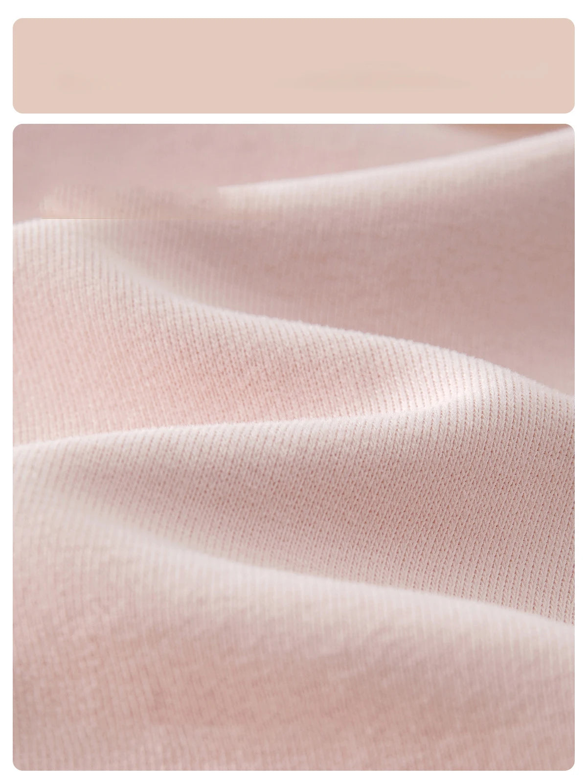 Macro close-up showing the soft, breathable pink cotton blend fabric texture of the baby girl knit cardigan sweater.