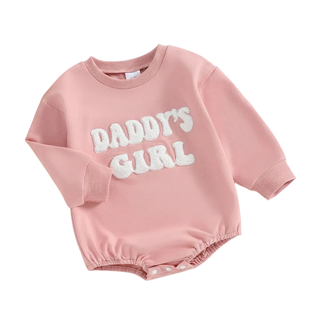 Angled front view of the pink "Daddy's Girl" long sleeve baby bubble romper.