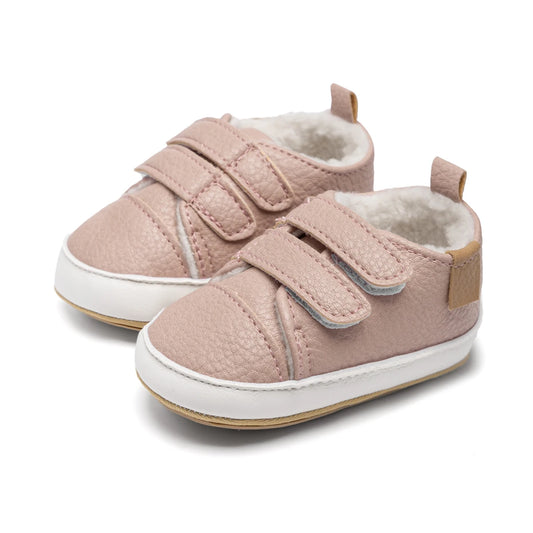 Pair of pink fleece-lined infant winter sneakers with double adjustable straps and soft white soles.