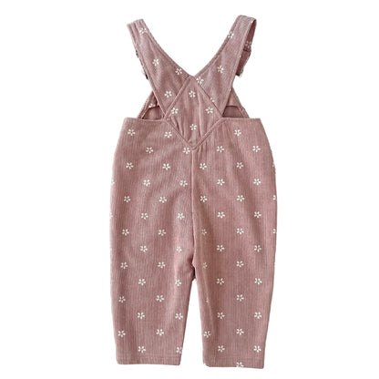 Back view of baby and toddler girl pink floral corduroy overalls showing the criss-cross suspender strap design.