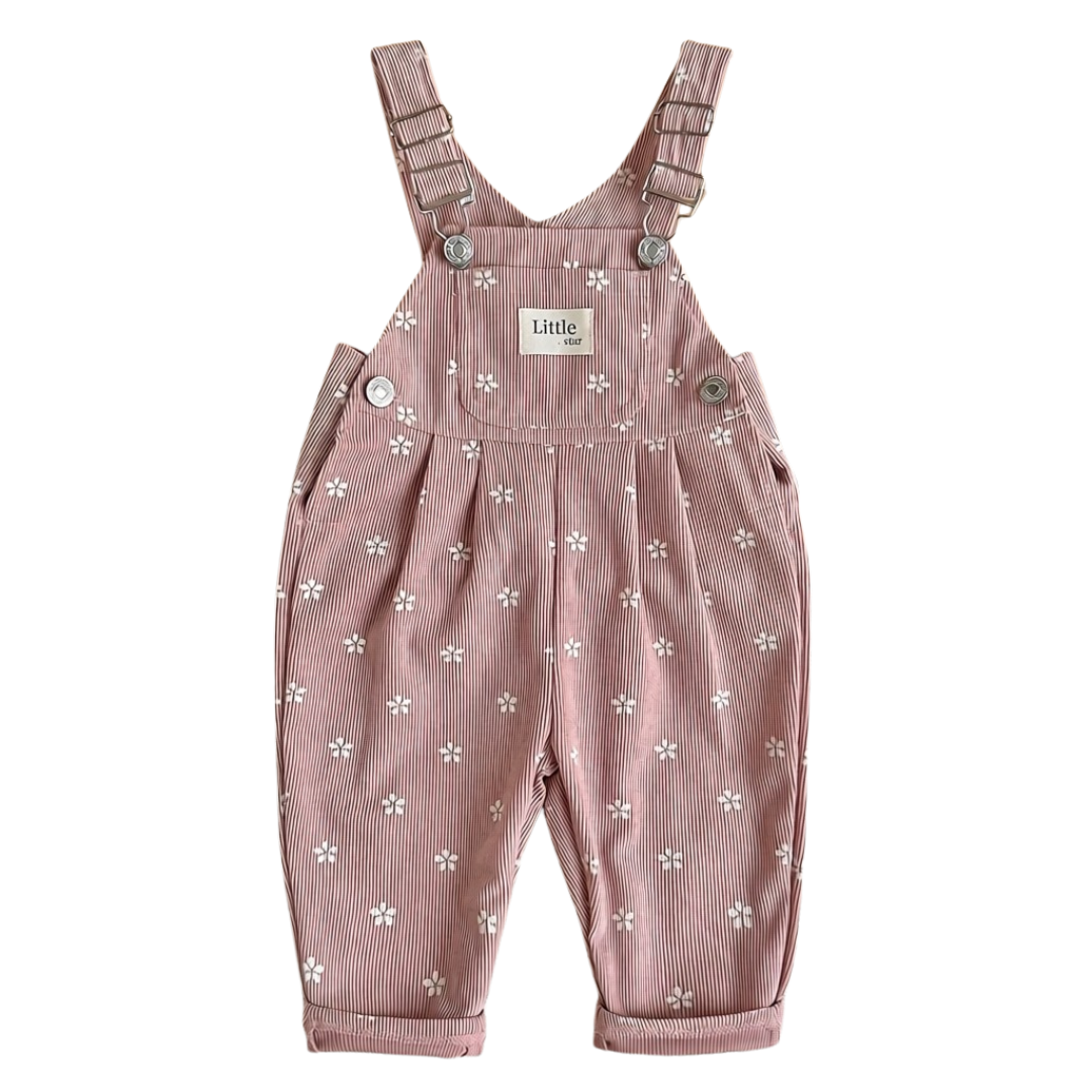 Front view of baby and toddler girl pink floral corduroy overalls featuring a front pocket and metal buckles on a white background.