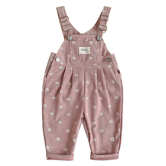 Front view of baby and toddler girl pink floral corduroy overalls featuring a front pocket and metal buckles on a white background.