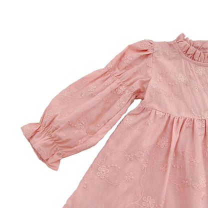 Upper front detail of a pink floral toddler dress showing long bishop sleeves and a gathered waist.