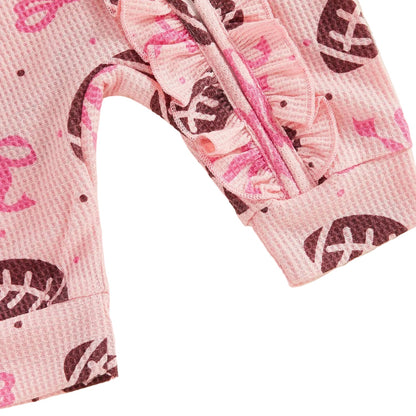 Back view of the pink baby girl long-sleeve jumpsuit and matching bow headband, showing the all-over football pattern.