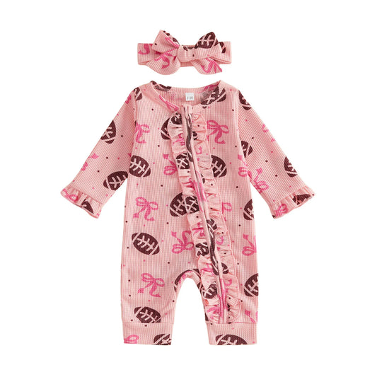 Front view of a pink waffle-knit baby girl romper with football and bow print, featuring a ruffle zipper and matching headband on a white background.