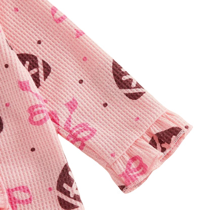 Close-up showing the soft ankle cuffs and textured waffle-knit fabric on the pink baby girl football outfit.