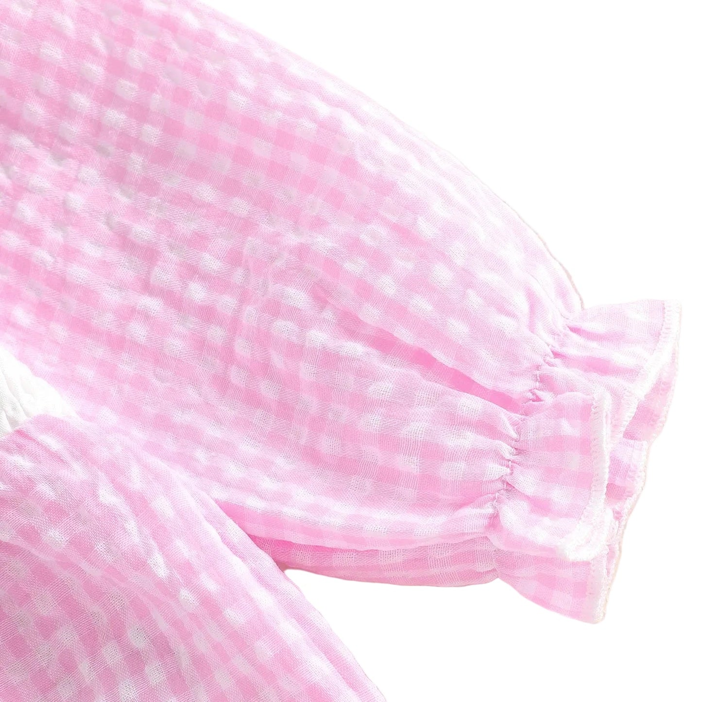 Close-up of the ruffled elastic cuff on the long sleeve of the pink gingham baby girl football romper.