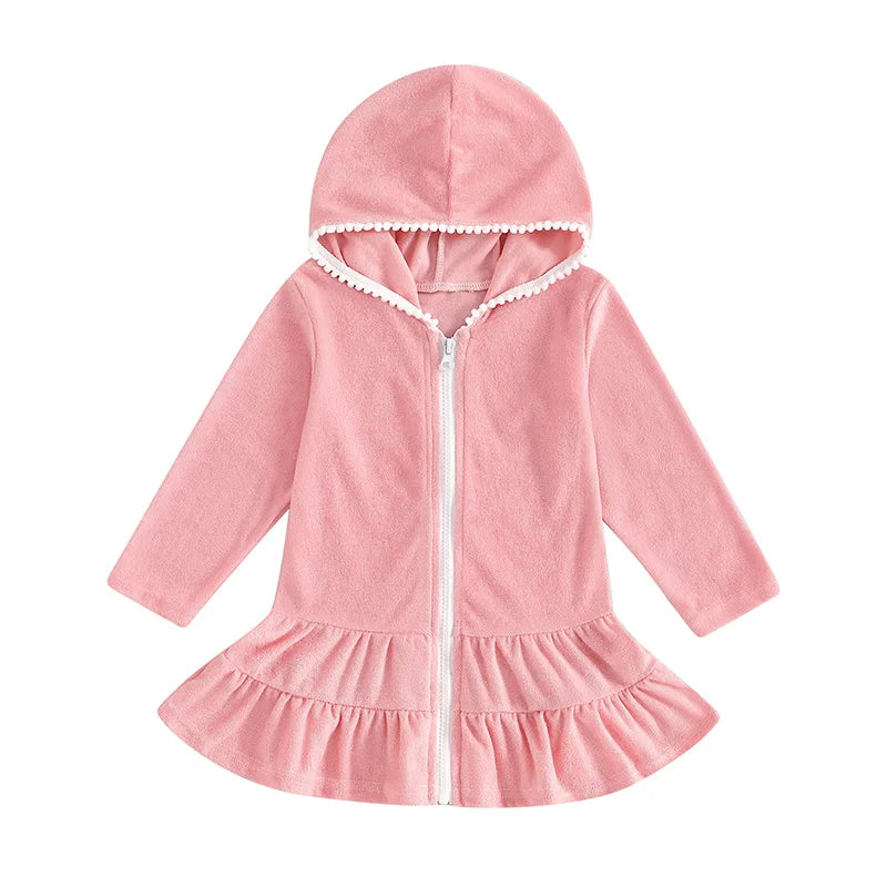 Front view of a pink long sleeve hooded swim coverup for girls featuring a white zipper and ruffle hem.