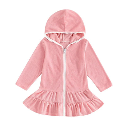 Front view of a pink long sleeve hooded swim coverup for girls featuring a white zipper and ruffle hem.