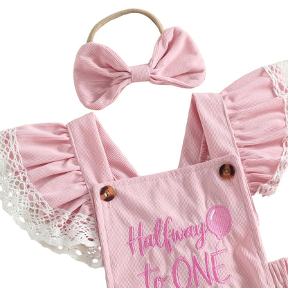 Close-up of the pink baby girl 6-month birthday romper highlighting the "Halfway to ONE" pink embroidery and button details.