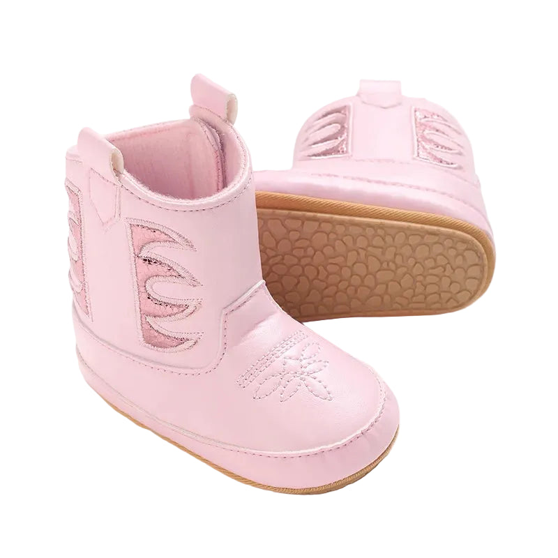 Two pink baby girl western boots, one facing forward to show toe stitching and one turned to show the side profile and rubber sole.