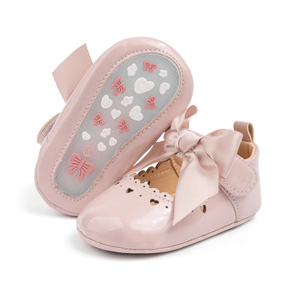 Bottom of a pink baby shoe displaying the flexible anti-slip sole with textured grip.