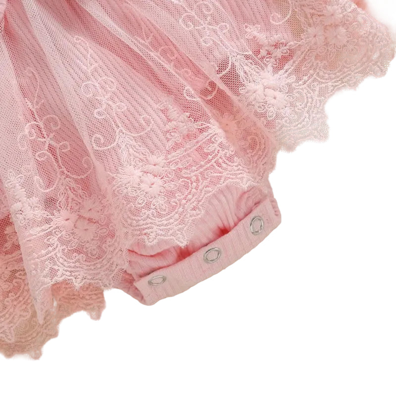 Close up of the delicate pink lace mesh tutu skirt and bottom crotch snap closures on the baby girl romper.