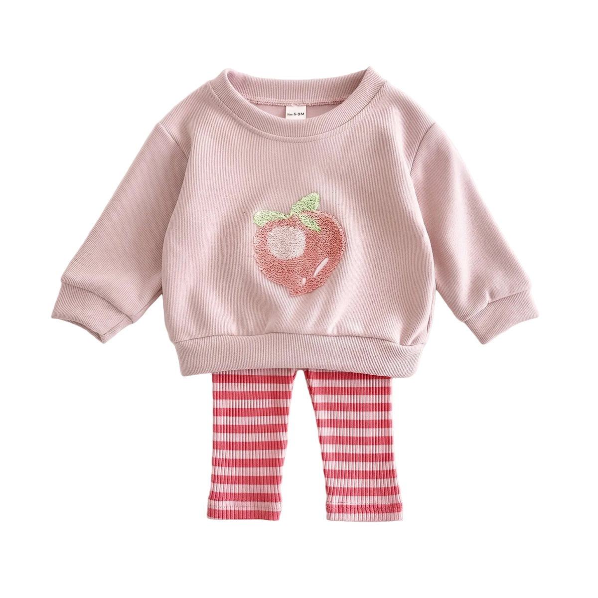 Flat lay of a baby and toddler girls two-piece outfit featuring a pink long-sleeve sweatshirt with a peach graphic and pink-and-white striped leggings on a white background.