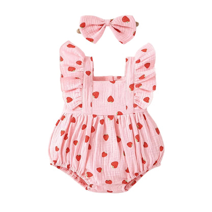 Pink strawberry print muslin baby girl bubble romper and matching bow headband set on a white background.