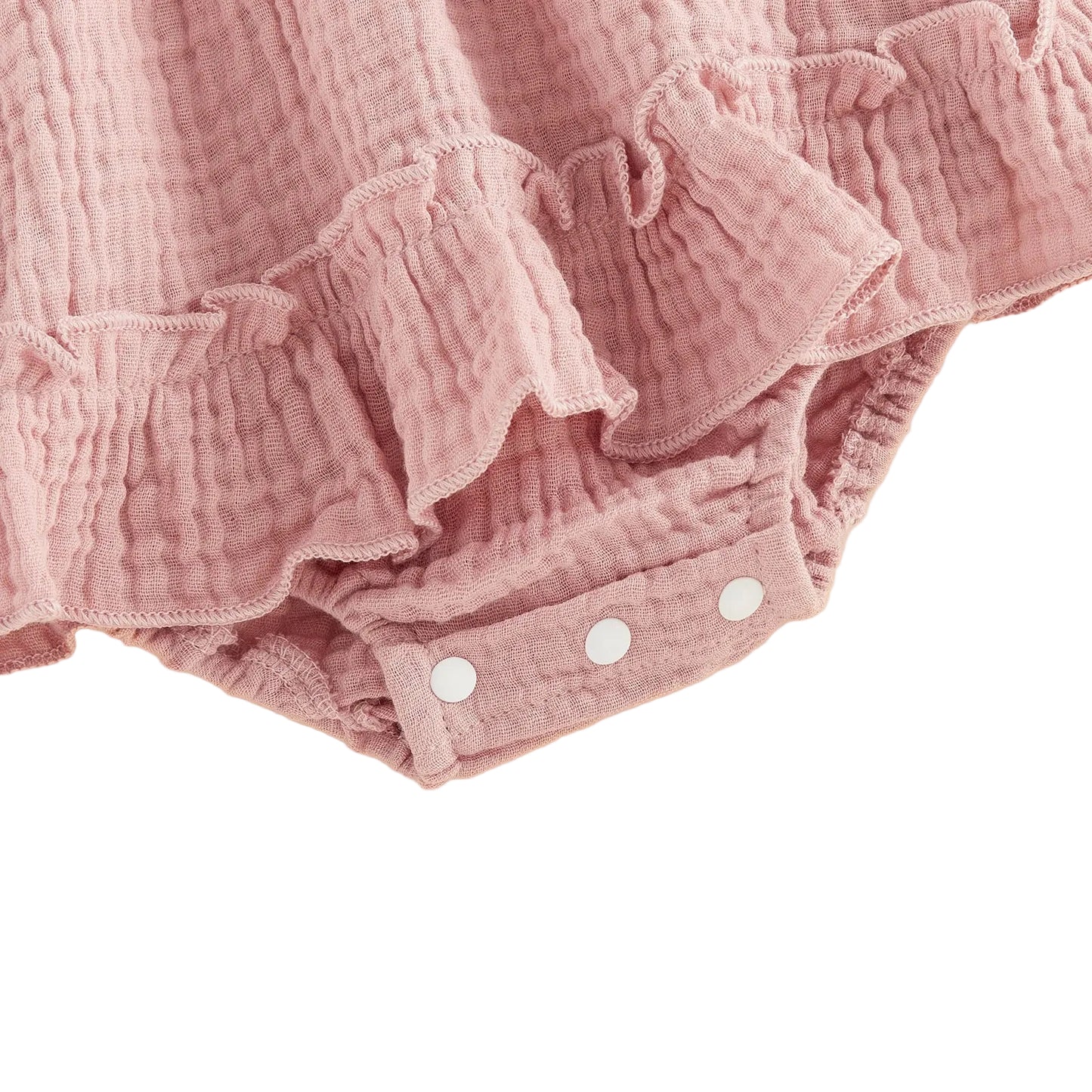 Close-up showing the convenient bottom snap closure and delicate ruffled leg trim on the pink strawberry baby romper.