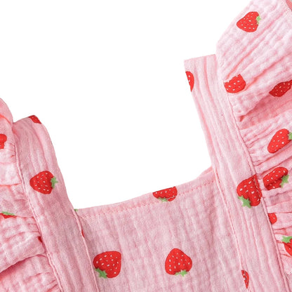 Close-up of the square neckline and flutter ruffle shoulder straps on the pink strawberry print baby romper.