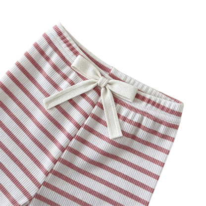 Close-up of the pink and white striped baby leggings featuring a decorative bow at the elastic waistband.