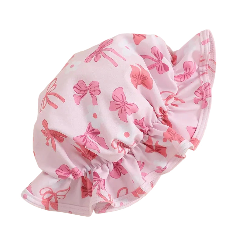 Pink sun hat with bow pattern on a white background