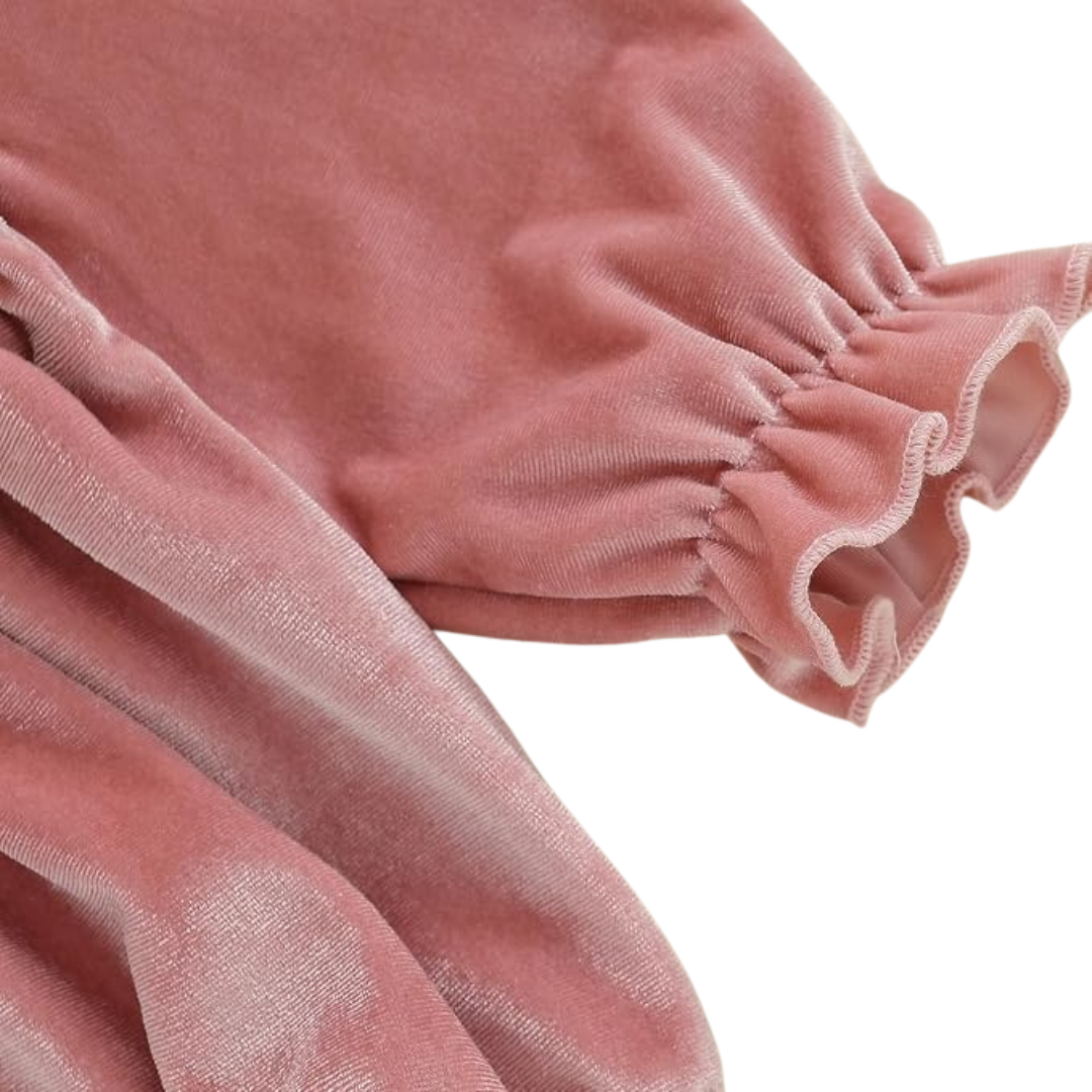 Close-up of long sleeve elastic ruffled wrist cuff on baby pink velvet bubble romper