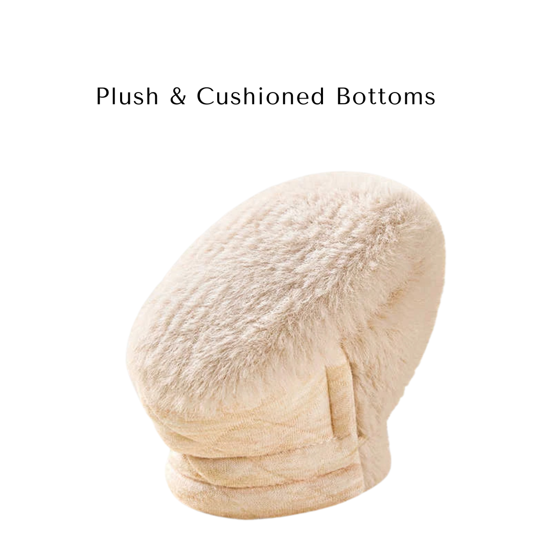 Bottom angle of a beige baby bootie showing the plush and cushioned fleece sole.