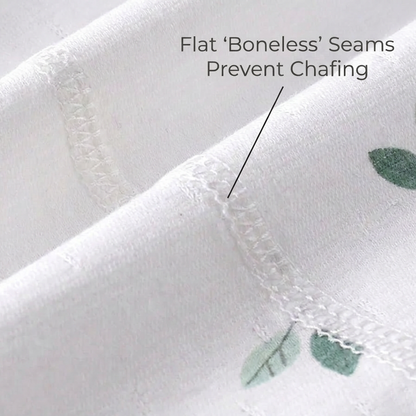 Macro view of the flat-lock stitched inner seams on the white pure cotton baby clothing, pointing out that flat boneless seams prevent chafing.