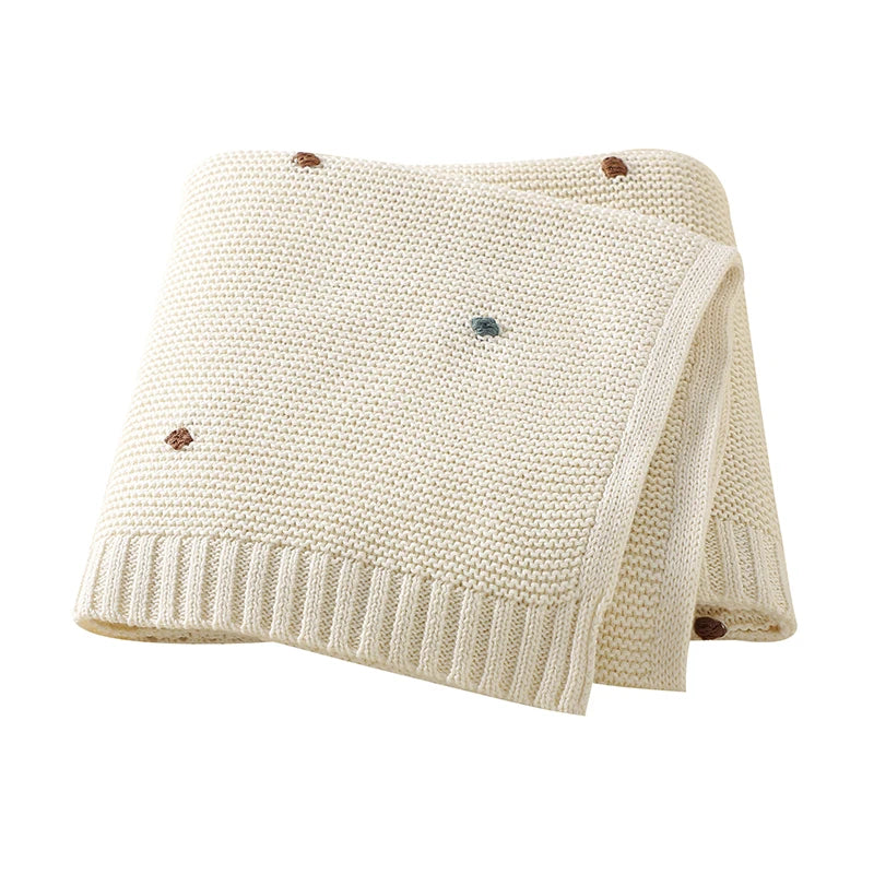 Creamy Oat Milk white 100% cotton knitted baby blanket showing the detailed popcorn stitch and soft texture.
