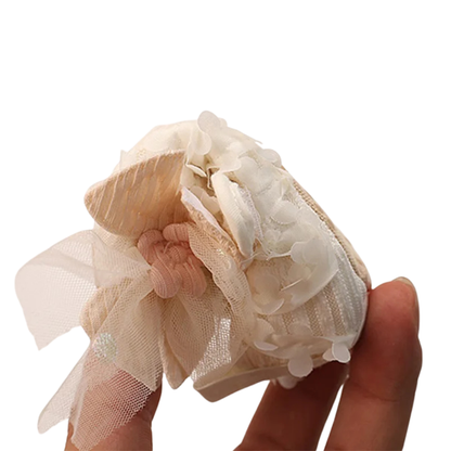 Detailed view of 3D fabric petals and tulle bow accent on Kidsely baby girl princess shoes.