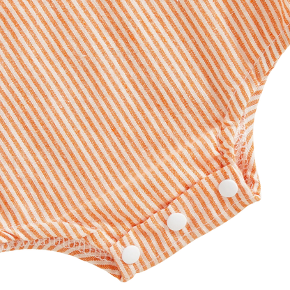 Close-up detail of the bottom snap closures on the orange seersucker-style baby bubble romper.