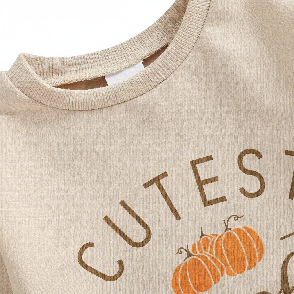 Close-up detail of the ribbed crew neckline and shoulder seam on the beige baby sweatshirt romper.