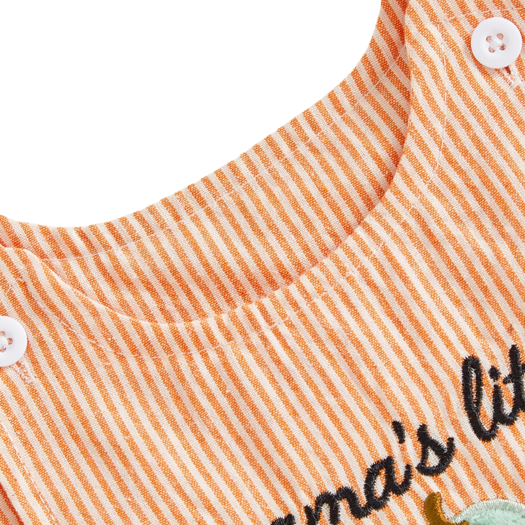 Close-up detail of the round neckline and white shoulder buttons on the orange striped baby romper.