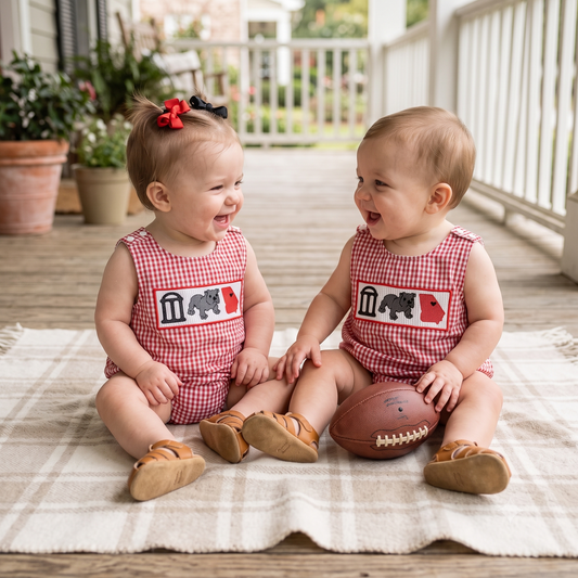 Kidsely baby boy and girl wearing red and black gingham smocked game day rompers with embroidered bulldog state motif styled for tailgating